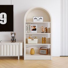 a white book shelf in the corner of a room