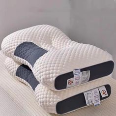 two pillows are stacked on top of each other