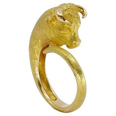 Crafted by esteemed jeweler George L'Enfant for Cartier Paris in the 1970s, this 18k gold ring showcases a bold bull Taurus motif, symbolizing strength and resilience. Sized at 7.5, it boasts a weight of 13.1 grams, offering both substance and elegance to the wearer. George L'Enfant, a prominent figure in the world of jewelry design, was renowned for his innovative creations and meticulous craftsmanship. Born in France, L'Enfant's journey in the art of jewelry-making began at a young age, eventu Bull Taurus, Bull Ring, Taurus Bull, 18k Gold Ring, The 1970s, Luxury Jewelry, Cartier, Fashion Rings, Gold Ring