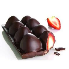 chocolate covered strawberries are sitting on a white surface