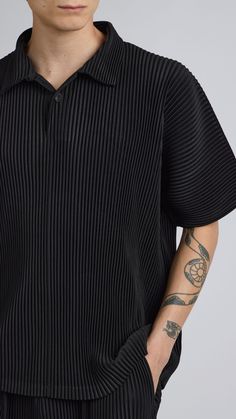 One Size. Fits XS-LColor: BlackPleated MaterialQuarter Button UpShort Sleeve100% PolyesterDry Clean OnlyBy The NKC Store Product MeasurementsChest: 132cm / 52inLength: 66.04cm / 26in Model is 185cm / 6'1" wearing size O/S Black Tops With Buttons And Casual Collar, Black Summer Polo Shirt With Collared Neckline, Black Collared Polo Shirt For Summer, Black Polo Shirt With Button Closure, Black Summer Polo Shirt With Button Closure, Black Polo Shirt With Button Closure For Summer, Modern Black Collared Polo Shirt, Modern Black Collared Top, Black Relaxed Fit Tops With Buttons