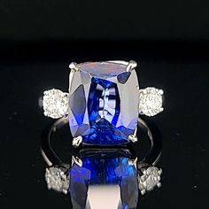 This vintage platinum three-stone ring features a stunning cushion-shaped lab-grown blue sapphire as its center stone, with two lab-grown diamonds on either side. The ring is perfect for special occasions like engagements, weddings, anniversaries, birthdays, Valentine's Day, Christmas, Mother's Day, or graduation, with adjustable sizing to fit a size 7.5 finger. GORGEOUS vintage platinum  engagement three stones ring gem lab-grown blue sapphire in a cushion shape,  Center set gorgeous blue sapph Fine Jewelry Sapphire Ring With Cushion Cut, Sapphire Cushion Cut Diamond Ring In Platinum, Asscher Cut Sapphire Three Stone Ring For Formal Occasions, Platinum Sapphire Ring With Prong Setting In Cushion Cut, Elegant Sapphire Ring With Vvs Clarity Cushion Cut, Luxury Three Stone Asscher Cut Sapphire Ring, Three Stone Sapphire Ring With Cushion Cut Diamond, Three Stone Radiant Cut Sapphire Ring, Asscher Cut Three Stone Sapphire Ring For Formal Occasions