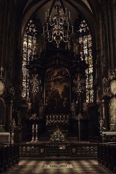 the interior of a church with stained glass windows and pews in front of it