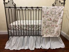 a baby crib with a blanket on top of it