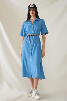 Introducing our Blue Maxi Shirt Dress with Polo Collar, a versatile and stylish piece perfect for spring and summer. This dress features a relaxed fit and maxi length, offering both comfort and elegance for any occasion.  Crafted from lightweight woven fabric, this dress is breathable and airy, making it ideal for warmer weather. The polo collar adds a touch of sophistication, while the button-up closure and short sleeves provide a classic and timeless look.  The dress comes with a belt made from the same fabric, allowing you to cinch the waist for a more defined silhouette or wear it loose for a relaxed vibe. Whether you're heading to a casual outing, a beach vacation, or a weekend brunch, this dress is sure to make a statement.  The model is wearing size S, with measurements of 33-24-36 Maxi Shirts, Maxi Shirt Dress, Blue Maxi, Romper Pants, Polo Collar, Sweater Coats, Hat Hairstyles, Medium Blue, Woven Fabric