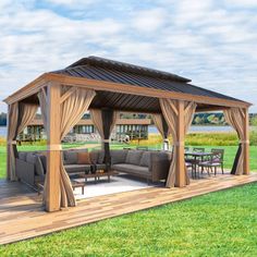 a gazebo with couches and tables in the grass