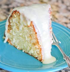 a slice of cake with white icing on a blue plate