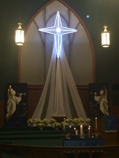 a lighted christmas star above the altar in a church