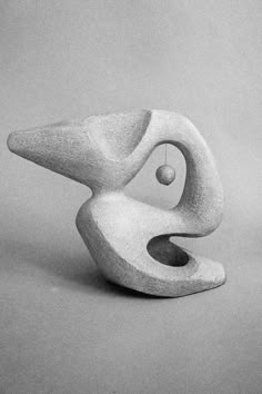 a black and white photo of a sculpture on a gray background with the shape of a person's head