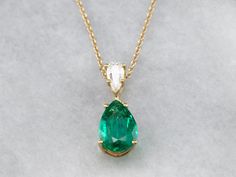 This lovely necklace was crafted in our shop, using both vintage and modern pieces. The center gem is a deep, gorgeous green emerald from our collection! We've used a brilliant diamond as an accent, and set them both in a simple yellow gold pendant with clean, simple lines. Set perfectly on a yellow gold rolo 16-inch chain, making this stunning piece ready to wear or gift! Metal: 18K Yellow Gold Gem: Emerald 2.57 Carats Gem Measurements: 12.0 x 8.2 mm, Pear Cut Accents: Diamond .42 Carats, F in Emerald And Diamond Necklace, Chain Making, Emerald Necklace, Lovely Necklace, Yellow Gold Pendants, Emerald Jewelry, Green Emerald, Brilliant Diamond, Simple Lines