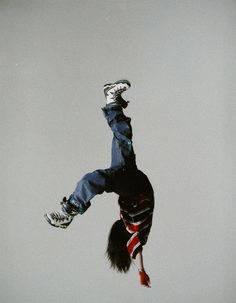 a man flying through the air while riding a snowboard