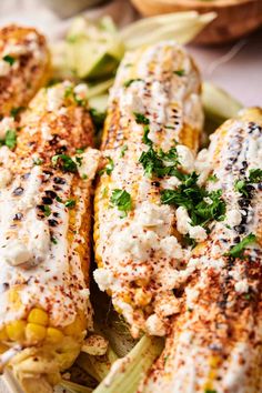 grilled corn on the cob topped with sour cream and parmesan cheese