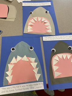 three paper cut outs with shark's teeth on them