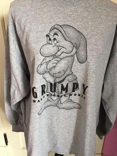 "Vintage 1990's Y2K long sleeve Tee Shirt with *GRUMPY* on it. Gray in color. Made of 90% Cotton and 10% Polyester. Tagged size XL. Go by the measurements below. *MORE INFORMATION BELOW* CONDITION: No issues noted. MEASURES: Chest/Bust~48\" Bottom edge~52\" Sleeve length~21\" Shoulder seam to shoulder seam~23\" Back of collar to bottom~29\" *WE APOLOGIZE~BUT WE NO LONGER SHIP TO GERMANY, ITALY OR SPAIN. IF ORDERS COME IN FROM GERMANY, ITALY OR SPAIN, WE WILL HAVE TO CANCEL THEM AND REFUND YOUR M Retro Long Sleeve Pre-shrunk Sweatshirt, Vintage Long Sleeve T-shirt With Screen Print, Vintage Long Sleeve T-shirt For Winter, Retro Gray Long Sleeve Tops, Retro Long Sleeve Tops With Screen Print, Oversized Long Sleeve Shirt With Screen Print, Vintage Long Sleeve Sweatshirt With Graphic Print, Retro Long Sleeve Shirt For Streetwear, 90s Long Sleeve Pre-shrunk Tops