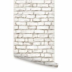 an old brick wall with white paint on it