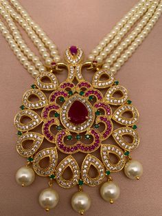 Peacock multi stone pendent Pearl Raani Haar with matching earringsColor : GoldenSize : Necklace Length : Approx 30 Inches; Pendent Length : 3 Inches; Earring Length : 2.25 InchesStones : Multi Color Stones CZ Green Beads and Pearls Ruby Jewelry Set With Stone Work As Gift, White Pearl Pendant Jewelry For Festivals, Red Pearl Pendant Jewelry For Gift, Red Pearl Pendant Jewelry Gift, Traditional White Teardrop Necklaces, Traditional White Teardrop Necklace, Red Kundan Pendant Necklace For Festivals, Red Pendant Kundan Necklace For Festivals, White Peacock Design Jewelry For Celebration