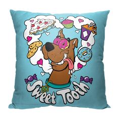 a blue pillow with a cartoon dog on it's face and donuts in the background