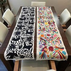 the table runner is decorated with colorful flowers