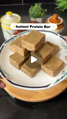 a person holding a plate with food on it and the words instant protein bar in front of them