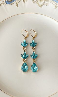 "Pair of long earrings featuring 8x4mm marquise and 14x10mm teal Swarovski crystals. 2 7/8\" long. Thanks for stopping by!" Elegant Turquoise Drop Crystal Earrings, Elegant Turquoise Teardrop Earrings For Party, Lady Aesthetic, Graduation 2025, Long Crystal Earrings, Prom 2025, Teal Earrings, Earrings Chandelier, Prom Earrings