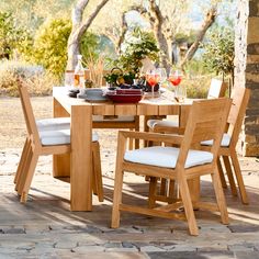 a wooden table with white chairs around it