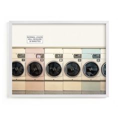 a row of washers sitting next to each other in front of a white wall