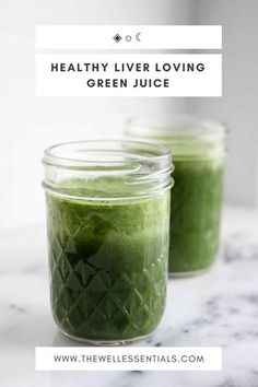 two jars filled with green juice sitting on top of a marble counter next to each other