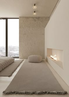 an empty room with a large rug on the floor and a fire place in the wall