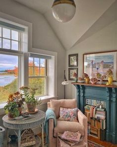 a living room filled with furniture and a fire place next to a window covered in pictures