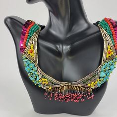 Branded by Seyyah, this colorful "social necklace" is a perfect staple pieces to elevate your everyday look. Crochet based embroidery statement necklace Adorned with seed and bugle beads, sequins, and semiprecious gemstones Two snaps to adjust the length Black crochet base length: 19-21", weight 1.6 oz About the brand: Seyyah is a brand that offers bold, unique, and colorful accessories inspired by travels around the world... and most importantly help to empower women. The brand "provides fair w Festival Multicolor Beaded Bib Necklace, Handmade Multicolor Beaded Necklaces For Party, Artisan Multicolor Beaded Necklaces With Fringe, Artisan Multicolor Beaded Necklace With Fringe, Party Embellished Beaded Necklaces With Round Beads, Unique Multicolor Beaded Necklaces For Party, Bohemian Embellished Necklaces For Party, Bohemian Embellished Necklace For Party, Multicolor Embellished Festive Jewelry