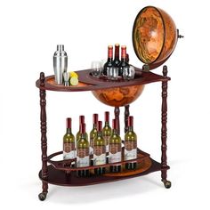 there is a wine rack with bottles and glasses on the top, next to an earth globe