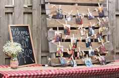 a wooden pallet with pictures hanging on it