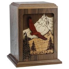 a wooden clock with an eagle on the front and mountains in the back that are carved into wood