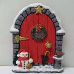 a red door with a snowman and santa clause on it