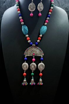 Dramatic, colorful oxidized silver Indian peacock necklace, with bead jhumka. The large central medallion is in the shape of an open peacock tail with a sparkly crystal border. Variety of bead shapes and sizes add visual interest. Perfect for tropical beach vacation as it is fun, lightweight and goes with all colors in your wardrobe. This is a very attractive necklace! You are certain to get many compliments! Necklace is 9.5 cm. Lobster claw clasp. Pendant measures 5 in x 3 in. including the dan Multicolor Temple Jewelry Pendant Set, Fusion Style Silver Beads Jewelry For Festivals, Multicolor Peacock Design Jewelry Gift, Multicolor Round Beads Temple Jewelry, Silver Dangle Jewelry With Peacock Design, Multicolor Fusion Jewelry For Navratri, Multicolor Peacock Temple Jewelry, Multicolor Peacock Design Temple Jewelry, Traditional Multicolor Peacock Design Jewelry