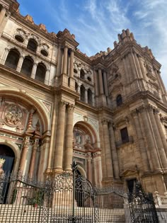 an old church with ornate architecture and wrought iron gates