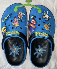 Elevate your summer footwear game with these Crocs + SpongeBob SquarePants Court Clogs. The unisex slip-on sandals feature a solid multicolor pattern and are made of rubber both inside and out. The clogs are perfect for any fan of the beloved cartoon character and are sure to make a statement wherever you go. This pair of Crocs is designed with a comfortable fit, making it perfect for casual wear. The outsole is made of rubber, ensuring durability and traction. These sandals are ideal for any occasion, from a day out with friends to a casual lunch. Get your hands on these limited edition Crocs + SpongeBob SquarePants Court Clogs today! Crocs Spongebob, Spongebob Crocs, Cool Crocs, Blue Crocs, Summer Footwear, Spongebob Squarepants, Out With Friends, Cartoon Character, Summer Shoes