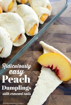 rolls with peaches and cream cheese are on a cutting board next to a glass dish