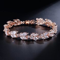 A classy bracelet for the modern bride! Featuring faceted cubic zirconia that catch the light from every angle, the bracelet is rhodium / 14K rose gold / 14K yellow gold plated for a flawless finish which perfectly enhances the intricate detailing and conveys a modern take on old elegance. The bracelet measures 0.5" wide (approx. 15mm) and 7" long (approx. 18cm). Closure is a secure fold-over clasp. Choose between Silver, Rose Gold and Yellow Gold finishes. To make your choice, select from the d Drop Earrings Bridal, Zirconia Bracelet, Trollbeads Bracelet, Bridal Earrings Studs, Crystal Earrings Wedding, Bridal Earrings Drop, Cz Bracelet, Bride Earrings, Crystal Bangle