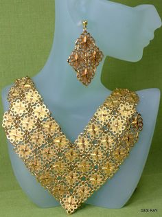 "Fabulous Etruscan Style gold plated filigree panel jewelry set/ parure: necklace, bracelet, clip on earrings and pierced earrings. The bracelet is 7 1/4\"\" long and 1 1/4\" wide and it has a flip over clasp. It has a 2\" long secure chain with the spring clasp The necklace , clip on earrings and the bracelet are marked \" D'Orlan\". The regular earrings are not marked. The inside necklace measurement is 17 inches and 5/8\" wide at the widest point.The middle ornamental piece is 6\" long and 3\ Gold Filigree Jewelry For Festive Occasions, Vintage Gold Jewelry Sets For Party, Gold-tone Pierced Jewelry For Party, Party Jewelry With Intricate Metal Design, Elegant Gold-tone Jewelry With Filigree, Party Jewelry Sets With Intricate Design, Handmade Gold Jewelry Sets For Party, Gold Filigree Necklaces For Parties, Vintage Gold Metal Jewelry Sets