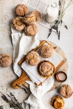 some sugary muffins are sitting on a table next to other pastries