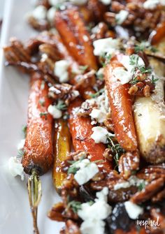 carrots with goat cheese and herbs on a white plate