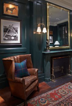 a living room filled with furniture and a fire place in front of a painting on the wall