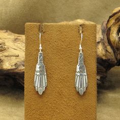 Add a touch of Western flair to your jewelry collection with these vintage dangle earrings. Made with sterling silver, these earrings feature a unique design that showcases the rich cultural heritage of the region. The earrings measure 2" tall including the hook by 7/16" wide. There is no artist's hallmark or stamps on the earrings. The intricate details make these earrings a must-have for any jewelry enthusiast. If you want to showcase your love for Southwestern art, these earrings are the perf Art Deco Dangle Pierced Earrings, Vintage Sterling Silver Dangle Jewelry, Vintage Sterling Silver Engraved Earrings, Vintage Engraved Sterling Silver Earrings, Silver Sterling Silver Art Deco Earrings, Sterling Silver Art Deco Dangle Jewelry, Vintage Engraved Dangle Earrings, Art Deco Sterling Silver Drop Earrings, Art Deco Sterling Silver Dangle Earrings