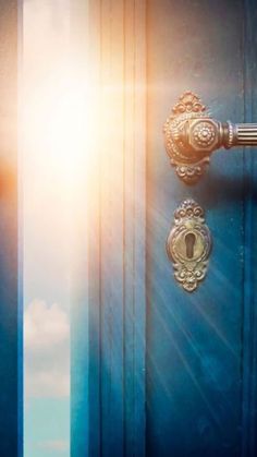 an open door with the light coming through it and blue sky in the back ground