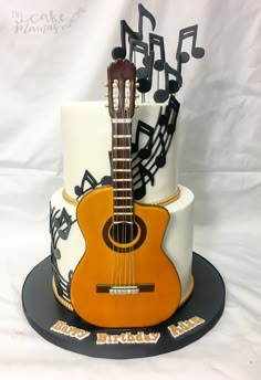 a guitar cake with musical notes on it