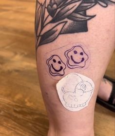 a person's leg with some stickers on it and flowers in the background