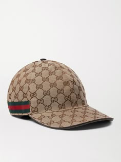 Gucci likes to reinvent itself every so often – think of the label's bold new logos and mascots from the animal kingdom, the interlocking 'GG' motif will always be the house trademark. This monogrammed canvas baseball cap has been made in Italy with signature striped webbing trims and a Velcro®-fastening leather back tab to adjust the fit. Designer Snapback Baseball Cap With Embroidered Logo, Designer Hats With Logo And Curved Brim, Luxury Baseball Cap With Embroidered Logo And Flat Brim, Luxury Logo Snapback Hats, Classic Gucci Hat With Flat Brim, Luxury Baseball Cap With Embroidered Logo And Visor, Luxury Baseball Cap With Logo And Curved Brim, Luxury Logo Cap, Luxury Flat Brim Baseball Cap With Embroidered Logo