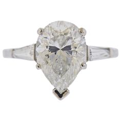 EGL certified 5.02ct pear shaped diamond G/SI2, set in platinum ring, with two side tapered baguetttes. Ring size 6. Center stone measures approx. 11.55 x 8.8 x 6.8mm. Weight - 5.1 grams. Gia Certified Pear-shaped Diamond Ring, Classic Teardrop Gia Certified Diamond Ring, Vvs Clarity Pear-shaped Diamond Ring, Gia Certified Platinum Pear-shaped Diamond Ring, Platinum Diamond Ring With Vvs Clarity, Pear-shaped, Vvs Clarity Pear-shaped Platinum Diamond Ring, Gia Certified Pear-shaped Platinum Wedding Ring, Platinum Engagement Ring, Platinum Diamond Engagement Rings