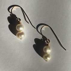 Classic beauties to throw on walking out the door. Whether going to work, getting coffee, or even a wedding these are the perfect earrings for any occasion. They are made with cultured pearls and gold filled materials. They are safe to wear in water, but should stay away from chemicals like soaps, lotions, and perfumes. Pearl White Dangle Earrings For Everyday, Classic 14k Gold-filled Pearl Earrings, Classic 14k Gold Filled Pearl Earrings, Pearl White Drop Earrings For Everyday Wear, Everyday Pearl White Drop Earrings, Handmade 14k Gold Filled Pearl Earrings For Everyday, 14k Gold Filled Pearl Earrings For Formal Occasions, Everyday Gold Pearl Hypoallergenic Earrings, Delicate Gold Pearl Earrings Nickel Free